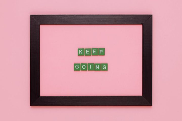 A framed motivational quote on a pink background for inspiration.